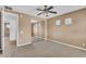 Bedroom featuring neutral carpet, ceiling fan, mirrored closet, and bright open doorway at 1755 E Tonto Dr, Chandler, AZ 85249