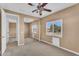 Bedroom featuring neutral carpet, ceiling fan, window with plantation shutters, and mirrored closet at 1755 E Tonto Dr, Chandler, AZ 85249