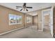 Bedroom featuring neutral carpet, ceiling fan, window with shutters, and mirrored closet doors at 1755 E Tonto Dr, Chandler, AZ 85249