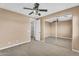 Bedroom features neutral carpet, ceiling fan, and mirrored closet maximizing space at 1755 E Tonto Dr, Chandler, AZ 85249
