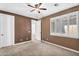 Bedroom features neutral carpet, ceiling fan, and plantation shutters for bright natural light at 1755 E Tonto Dr, Chandler, AZ 85249