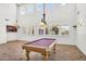 Bright game room with large windows, a pool table, and elegant lighting fixtures at 1755 E Tonto Dr, Chandler, AZ 85249