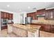 Gourmet kitchen features a large island, granite countertops, and stainless steel appliances at 1755 E Tonto Dr, Chandler, AZ 85249