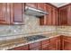 The kitchen features a gas cooktop, granite countertops, and ample cabinetry at 1755 E Tonto Dr, Chandler, AZ 85249