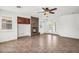 Cozy living room with a stone fireplace, ceiling fan, and access to the backyard at 1755 E Tonto Dr, Chandler, AZ 85249