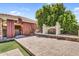 Outdoor entertainment area featuring a fireplace, pavers, and seating under a shaded, stone patio at 1755 E Tonto Dr, Chandler, AZ 85249
