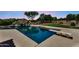 Backyard with a diving board and built-in rockslide that create the perfect pool for fun and relaxation at 1755 E Tonto Dr, Chandler, AZ 85249