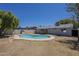 Private backyard features mature trees and lush grass surrounding a large, private pool at 17848 N 34Th Ln, Phoenix, AZ 85053