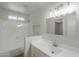 Bright bathroom with a shower-tub combo, stylish vanity lighting, and a large mirror at 17848 N 34Th Ln, Phoenix, AZ 85053