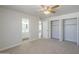 Spacious bedroom boasts neutral paint, carpet, ceiling fan, and direct access to the ensuite bathroom at 17848 N 34Th Ln, Phoenix, AZ 85053