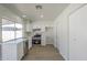 Modern kitchen featuring white cabinets, stainless steel appliances, and a large window at 17848 N 34Th Ln, Phoenix, AZ 85053
