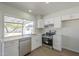Bright kitchen featuring white cabinets, stainless steel appliances, and a window with a backyard view at 17848 N 34Th Ln, Phoenix, AZ 85053