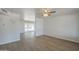 Open-concept living space with wood flooring, ceiling fan, and sliding glass doors to the backyard at 17848 N 34Th Ln, Phoenix, AZ 85053