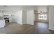 Bright, open-concept living space connecting the kitchen and living room with modern wood floors at 17848 N 34Th Ln, Phoenix, AZ 85053