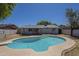 Large, private pool surrounded by mature trees and grass in the backyard at 17848 N 34Th Ln, Phoenix, AZ 85053