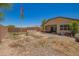 Backyard featuring a covered patio and ample space for outdoor activities under a clear sky at 18474 W College Dr, Goodyear, AZ 85395