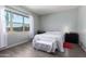 Serene bedroom featuring large windows, neutral walls, and sleek flooring at 18474 W College Dr, Goodyear, AZ 85395