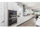 Bright kitchen showcasing stainless steel double ovens and plentiful cabinet space at 18474 W College Dr, Goodyear, AZ 85395