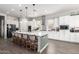 Bright, spacious kitchen with a large island, white cabinets, and modern stainless-steel appliances at 18474 W College Dr, Goodyear, AZ 85395