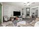 Inviting living room featuring a stylish brick accent wall, ceiling fan, and open layout at 18474 W College Dr, Goodyear, AZ 85395