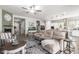 Open-concept living room showcasing a fireplace, modern decor, and seamless flow into the kitchen at 18474 W College Dr, Goodyear, AZ 85395