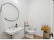 Bathroom with a pedestal sink, toilet, and hardwood floors at 19910 E Vallejo St, Queen Creek, AZ 85142