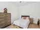 Minimalist bedroom featuring hardwood floors, neutral decor and a single bed at 19910 E Vallejo St, Queen Creek, AZ 85142