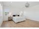 Bright bedroom featuring hardwood floors, plantation shutters, and modern lighting at 19910 E Vallejo St, Queen Creek, AZ 85142