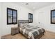 Comfortable bedroom with wood-look floors and natural light from the windows at 19910 E Vallejo St, Queen Creek, AZ 85142