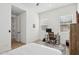 Light-filled bedroom with desk, chair, and large windows. Modern fan at 19910 E Vallejo St, Queen Creek, AZ 85142