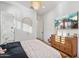 Bedroom with a woven bedframe, wood dresser, and ensuite bathroom at 19910 E Vallejo St, Queen Creek, AZ 85142