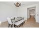 Elegant dining room with modern table, seating for six, and a view into the kitchen at 19910 E Vallejo St, Queen Creek, AZ 85142