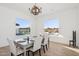 Bright dining room with a modern table, seating for six, and large windows with backyard views at 19910 E Vallejo St, Queen Creek, AZ 85142