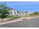 Charming single-story home with lush green lawn and well-manicured landscaping at 19910 E Vallejo St, Queen Creek, AZ 85142