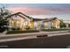 Striking exterior view of home at dusk with a manicured lawn, tasteful landscaping, and inviting walkway at 19910 E Vallejo St, Queen Creek, AZ 85142