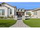 Charming single-story home featuring a brick pathway leading to a vibrant red front door at 19910 E Vallejo St, Queen Creek, AZ 85142