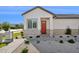 Charming home exterior with an inviting red front door, brick accents, and drought-resistant landscaping at 19910 E Vallejo St, Queen Creek, AZ 85142