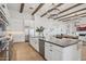 Open-concept kitchen with stainless steel appliances, an island with seating, and stylish countertops at 19910 E Vallejo St, Queen Creek, AZ 85142