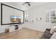 Bright living room with a entertainment center, television, and hardwood floors at 19910 E Vallejo St, Queen Creek, AZ 85142