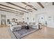 Spacious open concept living room featuring a sectional sofa and hardwood floors at 19910 E Vallejo St, Queen Creek, AZ 85142