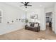 Living room featuring a ceiling fan, wood-look floors, and comfortable seating at 19910 E Vallejo St, Queen Creek, AZ 85142