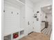 Bright mud room boasting built-in storage, coat hooks and beautiful tiled floors leading to the laundry room at 19910 E Vallejo St, Queen Creek, AZ 85142