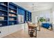 Bright home office with custom blue built-ins, hardwood floors, and modern decor at 19910 E Vallejo St, Queen Creek, AZ 85142