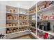 Well-organized pantry with shelves stocked with food items in baskets and containers at 19910 E Vallejo St, Queen Creek, AZ 85142
