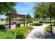 Park with shaded seating areas, landscaped walkways, and manicured grounds at 19910 E Vallejo St, Queen Creek, AZ 85142