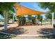 Community playground featuring climbing structure with shade canopies and seating at 19910 E Vallejo St, Queen Creek, AZ 85142