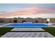 Backyard featuring an inviting pool with spa and basketball hoop, creating a relaxing outdoor oasis at 19910 E Vallejo St, Queen Creek, AZ 85142