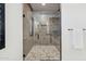 Frameless glass shower with mosaic floor and neutral tile at 19910 E Vallejo St, Queen Creek, AZ 85142