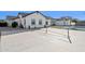 Large sport court with basketball hoop and tennis net situated near the pool and patio at 19910 E Vallejo St, Queen Creek, AZ 85142