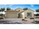 Inviting single-story home with a two-car garage, desert landscaping, and a classic tile roof at 20113 W Campbell Ave, Buckeye, AZ 85396